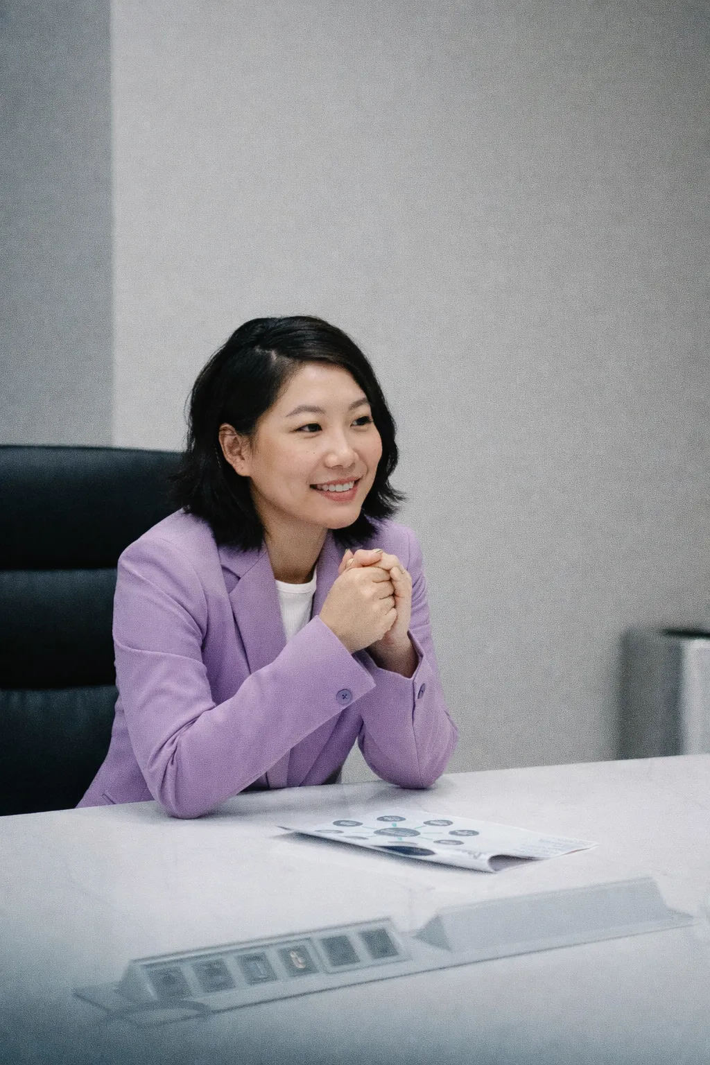 A business owner discussing client work at her desk